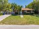 Charming single-story home with well-manicured lawn, mature trees, and a brick-paved driveway with privacy gate at 815 Kentucky Ave, St Cloud, FL 34769