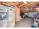 Spacious garage with ample storage, featuring a refrigerator and exposed ceiling, perfect for projects and organization at 815 Kentucky Ave, St Cloud, FL 34769