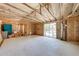 Spacious garage featuring unfinished walls, exposed beams, and a sliding glass door, awaiting personalized renovations at 815 Kentucky Ave, St Cloud, FL 34769