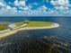 Aerial view of an island park with a covered gazebo and benches in a serene lakeside setting at 815 Kentucky Ave, St Cloud, FL 34769