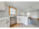 Renovated kitchen island boasts white cabinetry and stainless steel dishwasher at 815 Kentucky Ave, St Cloud, FL 34769