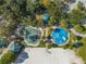Overhead shot of playground with splashpad, play structure, and sand volleyball court at 815 Kentucky Ave, St Cloud, FL 34769