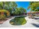 Backyard pool offers a private outdoor retreat with mature trees and a covered area for relaxation and entertaining at 815 Kentucky Ave, St Cloud, FL 34769
