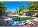 An inviting backyard oasis with a free-form pool, seating area, pergola and lush landscaping perfect for relaxing at 815 Kentucky Ave, St Cloud, FL 34769