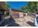 Exterior view of a rustic wooden shed in a backyard, surrounded by trees and landscaping at 815 Kentucky Ave, St Cloud, FL 34769