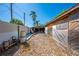 Backyard view of a wood shed showing the exterior with a corrugated metal fence on the left at 815 Kentucky Ave, St Cloud, FL 34769