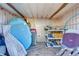 Interior of a shed with storage shelves, containers, pool floats, and various items stored at 815 Kentucky Ave, St Cloud, FL 34769