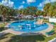 Colorful splash pad with various water features, benches, and shady trees at 815 Kentucky Ave, St Cloud, FL 34769