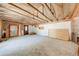 Spacious unfinished room with exposed beams, wood paneling, and a door for renovation at 815 Kentucky Ave, St Cloud, FL 34769
