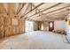 Large unfinished room with exposed insulation, slider, and a door, ready for customization at 815 Kentucky Ave, St Cloud, FL 34769