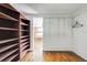 Walk-in closet with wooden shelves and metal hanging rods at 815 Kentucky Ave, St Cloud, FL 34769
