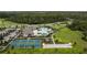 An aerial view of the community including the pool, clubhouse, pickleball courts, bocce ball and parking at 8817 Cruden Bay Ct, Davenport, FL 33896