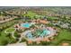 Stunning aerial shot of the community pool and amenities, showcasing lush landscaping at 8817 Cruden Bay Ct, Davenport, FL 33896