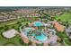 Overhead view of resort-style pools and beautifully landscaped grounds, showcasing the community's allure at 8817 Cruden Bay Ct, Davenport, FL 33896