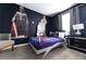 Charming bedroom featuring Star Wars themed decor, dark blue walls and carpet flooring at 8817 Cruden Bay Ct, Davenport, FL 33896