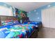 Charming themed bedroom featuring two beds, playful decor, and a welcoming atmosphere at 8817 Cruden Bay Ct, Davenport, FL 33896