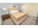 Luxurious bedroom with a king-size bed, tufted headboard, neutral tones, and stylish bedside tables at 8817 Cruden Bay Ct, Davenport, FL 33896