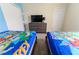 Comfortable bedroom featuring two beds, a dresser with a TV, and tasteful decorations at 8817 Cruden Bay Ct, Davenport, FL 33896
