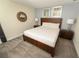 Cozy bedroom featuring a queen bed, two matching nightstands, and carpet flooring at 8817 Cruden Bay Ct, Davenport, FL 33896