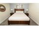 Warm bedroom featuring a queen bed, two nightstands, carpet floors, and neutral walls at 8817 Cruden Bay Ct, Davenport, FL 33896