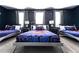 Spacious bedroom with three beds, Star Wars themed decor, and dark blue walls at 8817 Cruden Bay Ct, Davenport, FL 33896