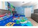 Themed bedroom showcasing two beds, a TV, and decor that creates a fun and imaginative space at 8817 Cruden Bay Ct, Davenport, FL 33896