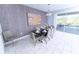 Well-lit dining area with a contemporary table setting and easy access to the outdoor pool area at 8817 Cruden Bay Ct, Davenport, FL 33896