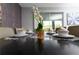 Elegant dining room featuring a dark wood table set for four, complete with dishes and a centerpiece at 8817 Cruden Bay Ct, Davenport, FL 33896
