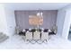 Open dining room showcasing modern decor, stylish lighting, and a spacious layout for comfortable dining at 8817 Cruden Bay Ct, Davenport, FL 33896