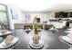 Beautiful dining room with a large table set for eight, overlooking the living room and kitchen at 8817 Cruden Bay Ct, Davenport, FL 33896