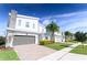 View of a street with modern two-story homes, brick-paved driveways, and well-maintained lawns at 8817 Cruden Bay Ct, Davenport, FL 33896