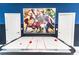 Close-up of an air hockey table in a vibrant game room with fun wall art at 8817 Cruden Bay Ct, Davenport, FL 33896
