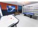 Spacious game room with air hockey, foosball, and a pool table, providing hours of entertainment at 8817 Cruden Bay Ct, Davenport, FL 33896