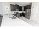 Stylish kitchen featuring black cabinets, stainless steel appliances, and white countertops at 8817 Cruden Bay Ct, Davenport, FL 33896