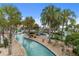 The winding community lazy river is landscaped with palm trees and tropical plants, and includes a water slide at 8817 Cruden Bay Ct, Davenport, FL 33896