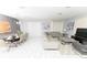Open-concept living and dining area with modern decor, sleek furniture, and bright, airy ambiance at 8817 Cruden Bay Ct, Davenport, FL 33896