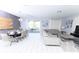 Open-concept space with modern furnishings, a dining area, and a view of the outdoor pool area at 8817 Cruden Bay Ct, Davenport, FL 33896