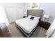 Cozy bedroom with a tufted headboard, plush bedding, and ample closet space for comfortable living at 8817 Cruden Bay Ct, Davenport, FL 33896