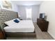 Serene bedroom featuring a large bed, soft lighting, and a clean, minimalist design at 8817 Cruden Bay Ct, Davenport, FL 33896