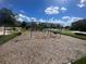 Community playground features a colorful jungle gym with slides and swings, and a bench for relaxing at 8817 Cruden Bay Ct, Davenport, FL 33896