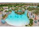 A winding lazy river with a water slide for all ages creates a relaxing oasis at this community pool at 8817 Cruden Bay Ct, Davenport, FL 33896