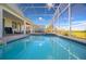Private screened pool area with a view of the green space, offering a relaxing outdoor retreat at 8817 Cruden Bay Ct, Davenport, FL 33896