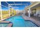 Sparkling pool with a screened enclosure, and a lovely outdoor seating area for relaxation at 8817 Cruden Bay Ct, Davenport, FL 33896