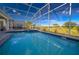 Screened pool with stunning golf course views, perfect for relaxation and outdoor enjoyment at 8817 Cruden Bay Ct, Davenport, FL 33896