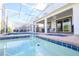 Relaxing pool and patio with a screened enclosure offer a refreshing escape in a private setting at 8817 Cruden Bay Ct, Davenport, FL 33896