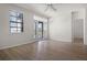 Bright living room with a ceiling fan, modern floors, large windows, and a sliding glass door leading to the balcony at 911 N Orange Ave # 550, Orlando, FL 32801