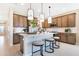 Modern kitchen with a central island, pendant lighting, and stainless steel appliances at 1011 Wisteria Way, Dundee, FL 33838