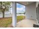 View of the home's backyard showing the patio, lawn, privacy fence, and mature tree at 105 Winchester Ln, Haines City, FL 33844