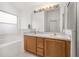 Bright bathroom featuring a double sink vanity, large mirror, and separate shower and tub at 105 Winchester Ln, Haines City, FL 33844