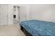 Bedroom featuring white walls, carpet and a wooden bed frame with a patterned blue bedspread and built in drawers at 105 Winchester Ln, Haines City, FL 33844